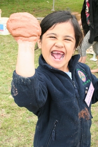 A young participant in last year's Enviroschools expo tries her hand at earth building at Kerikeri.